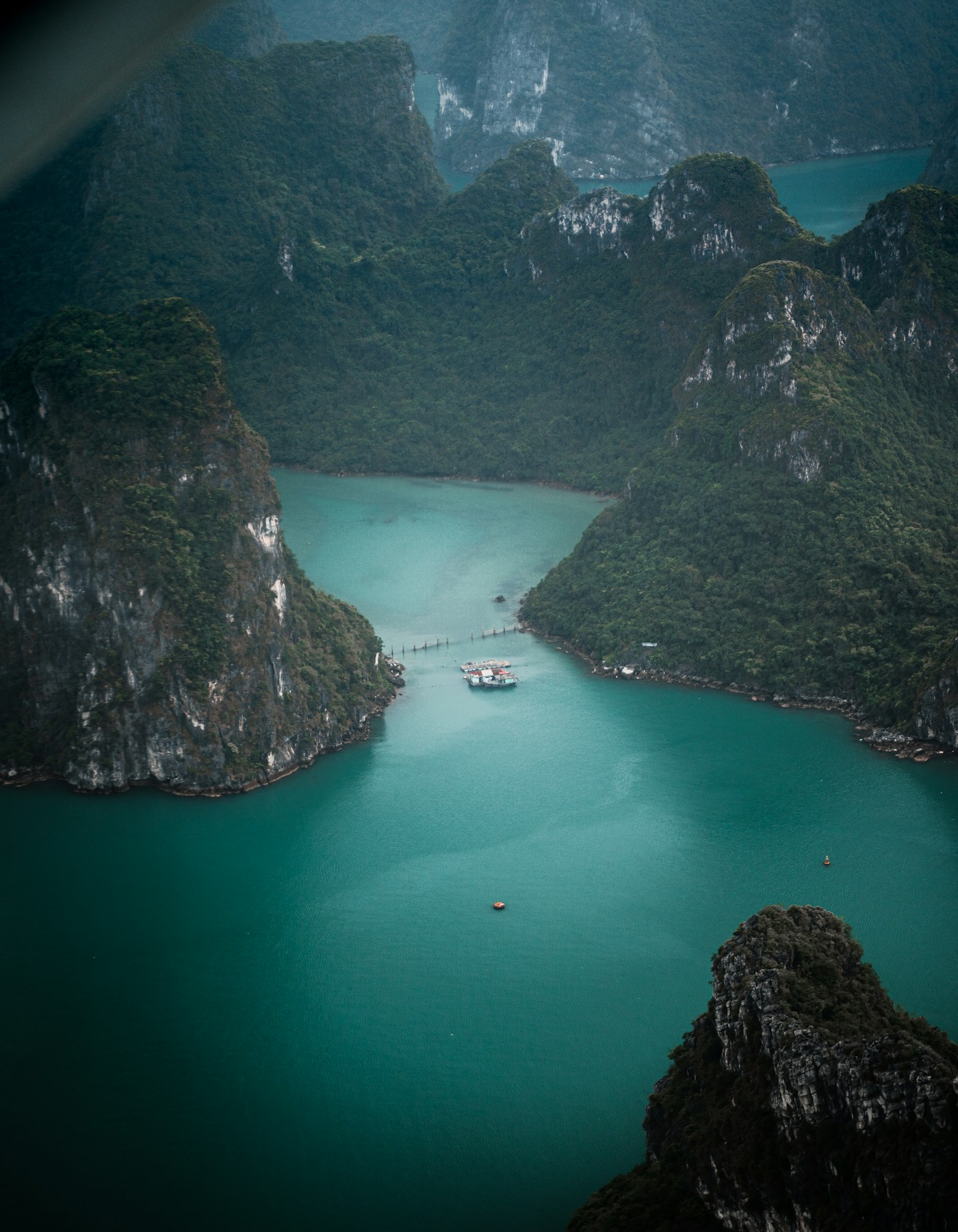 Lush limestone cliffs above the teal waters of Hạ Long Bay, Vietnam